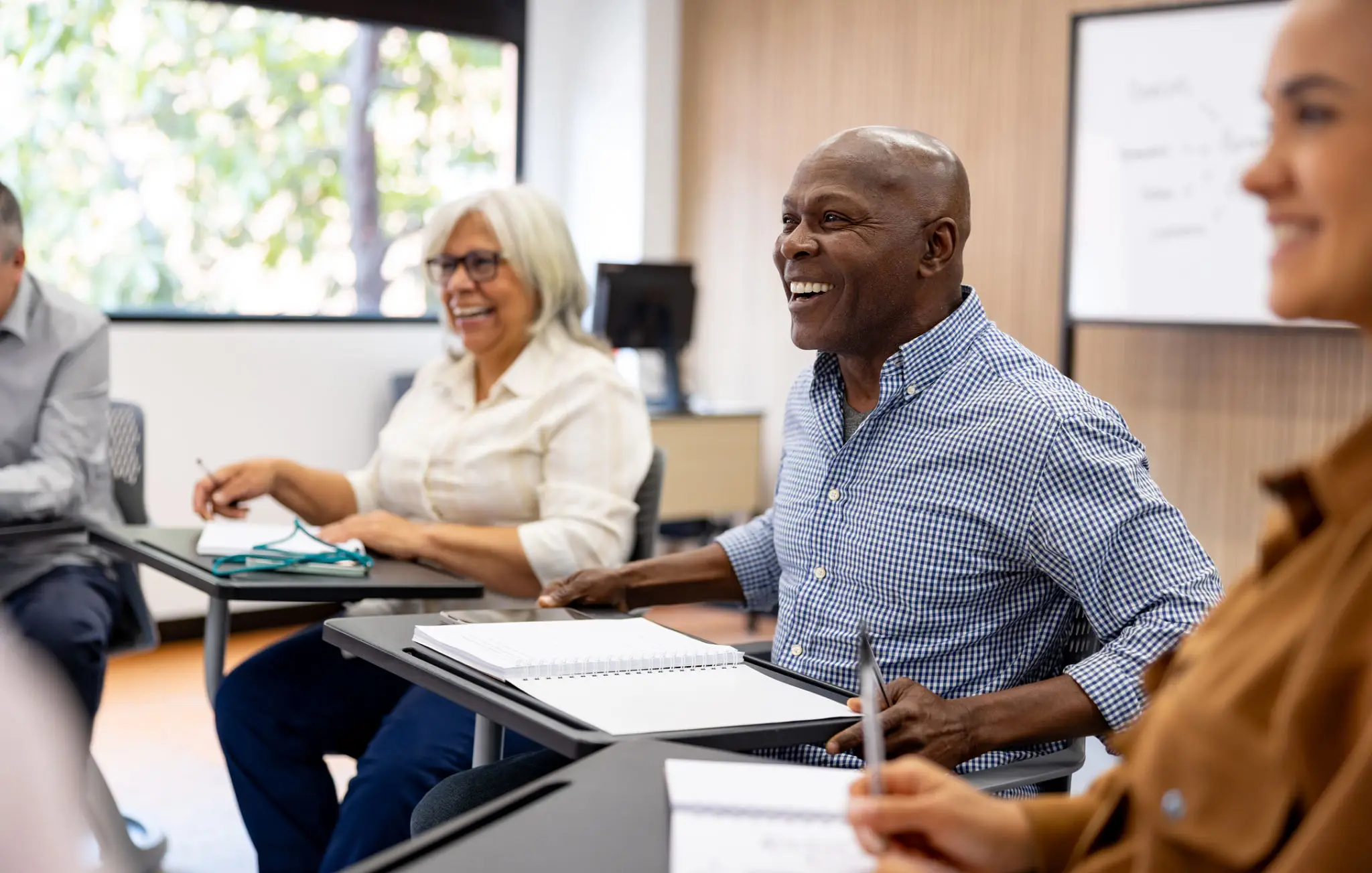 Adults engaged in a lively classroom discussion.